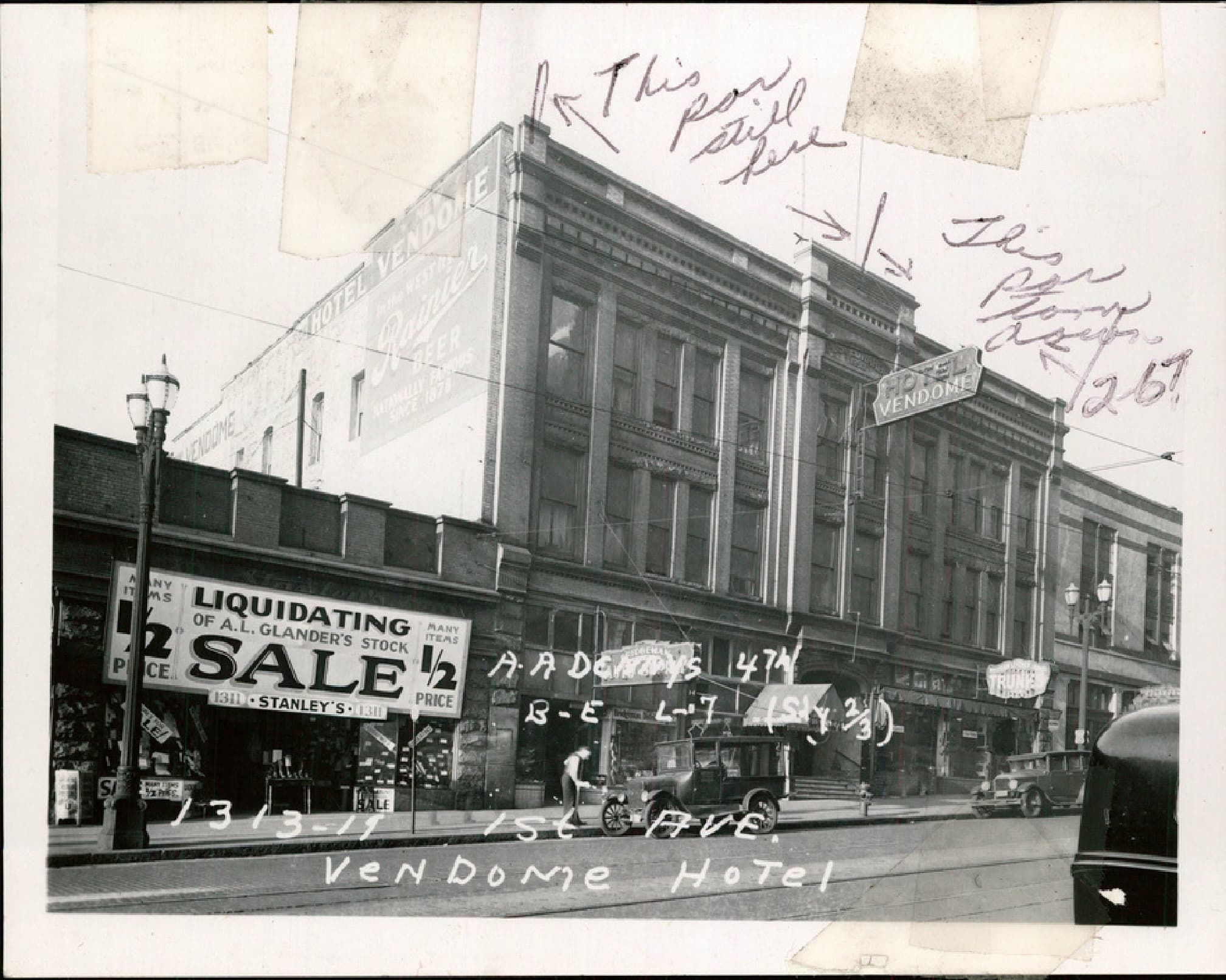 Black-and-white archival photograph from a King County tax assessment card showing the Hotel Vendome at 1313-19 1st Avenue around 1937 to 1941, at its full original width, with a Liquidating Sale storefront below and vintage cars parked at the curb
