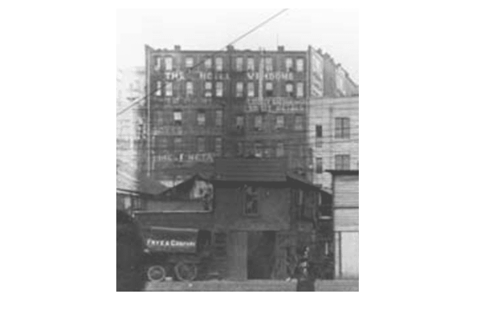 The rear facade of the Hotel Vendome in 1908, painted hotel signage on brick, photographed from the waterfront side by Asahel Curtis