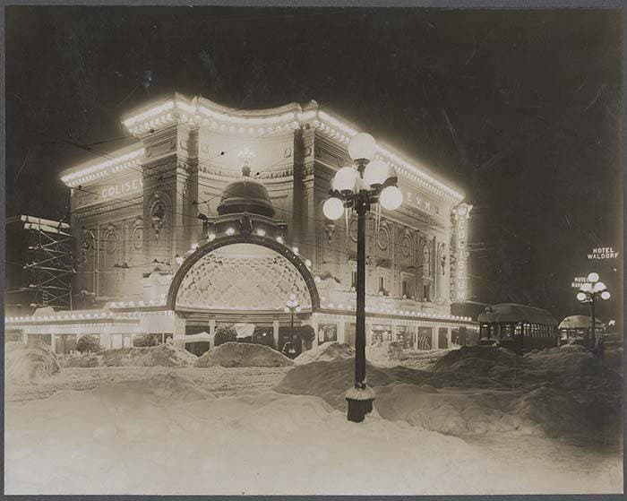 Coliseum Theatre exterior lit up at night in deep snow, February 1916